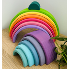 Colorful rainbow-shaped toy on a wooden surface 